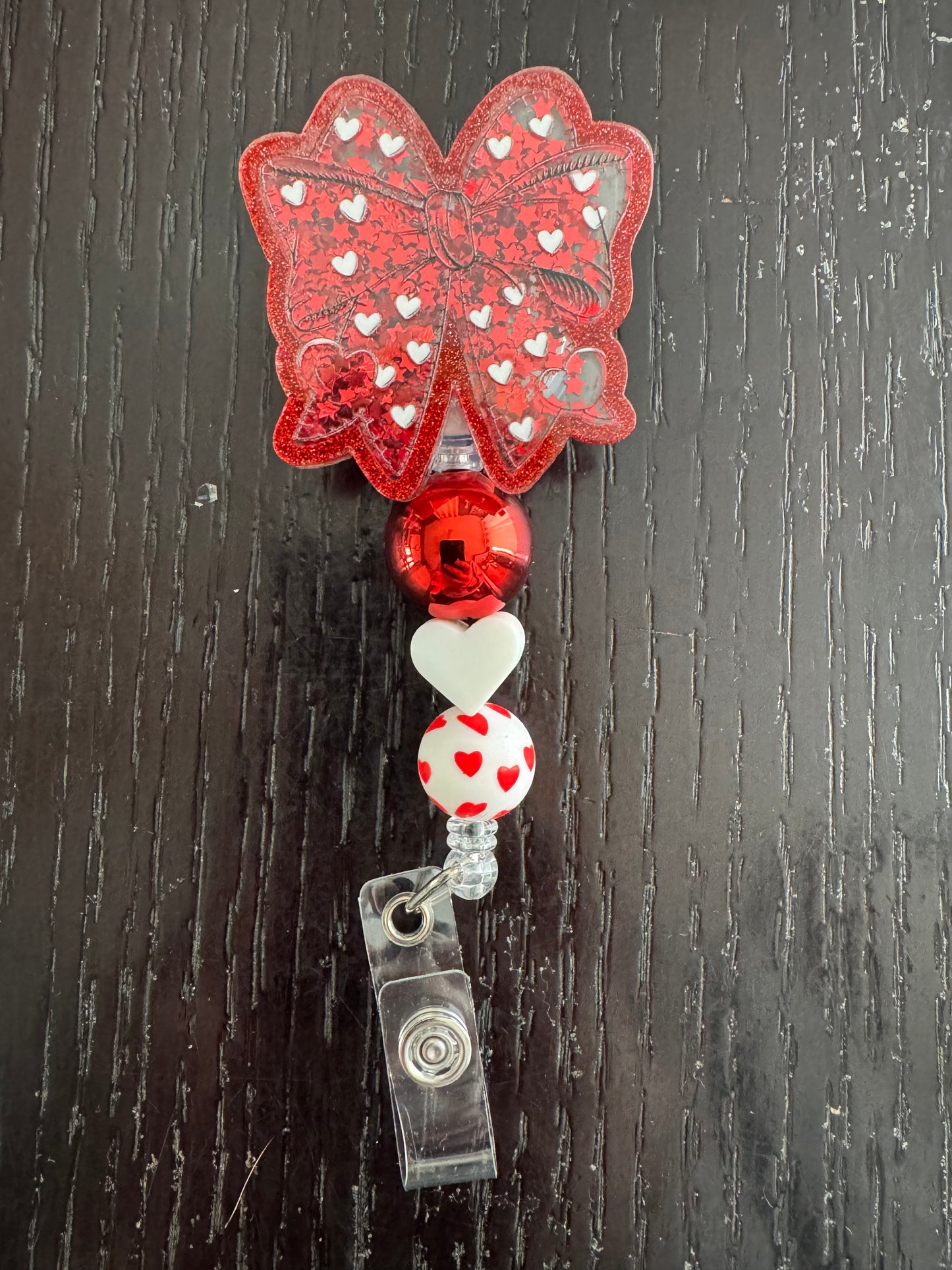 Heart bow shaker badge reel