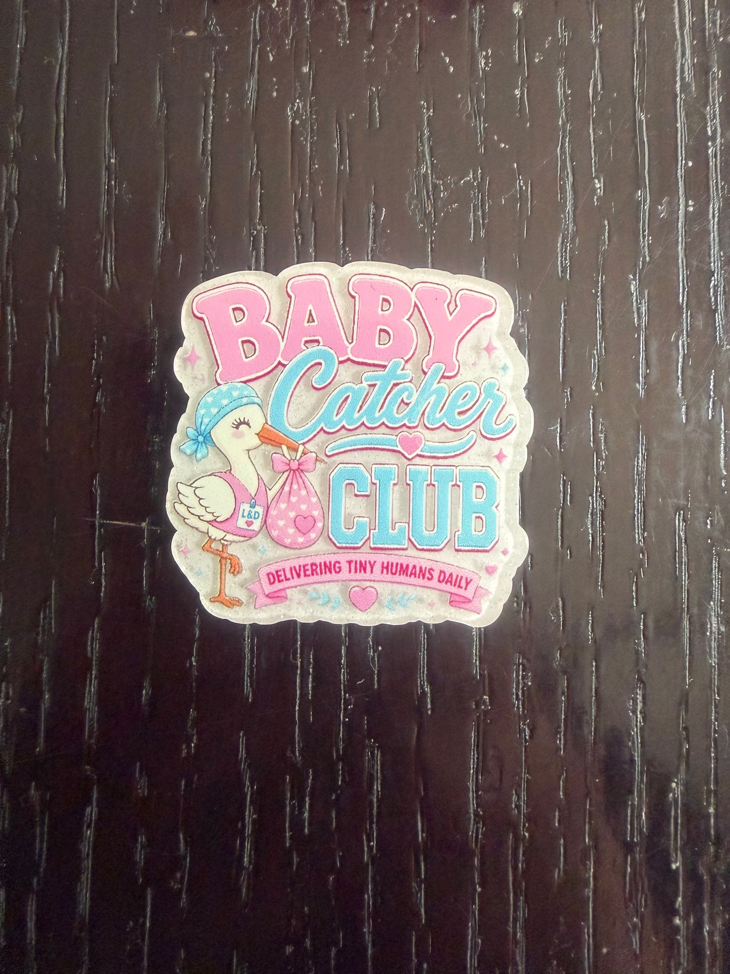 Baby catcher club badge reel